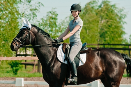 riding young woman portrait on horse in outdoor